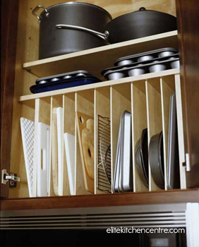 Organize lesser-used trays and bakeware in the cabinet above your fridge.